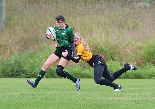 Samantha Gryba of the Dauphin Clippers runs the ball into the middle after scoring a try as she is tackled by  Faith Burtnick of the Crocus Plainsmen during the varsity girls rugby 7s provincial championship final at John Reilly Field. (Perry Bergson/The Brandon Sun)