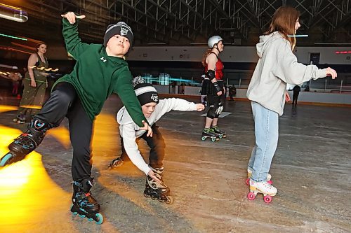 23032023
Grayson Hodgins and Grayson Swain skate during Roller Disco at the Sportsplex Arena on Thursday evening. The Wheat City Roller derby League was on hand to rent skates to interested roller-skaters without their own pair. Dozens of roller-skating enthusiasts were already in line before the event started and spent the event skating to music under the colourful lights and disco ball. 
(Tim Smith/The Brandon Sun)