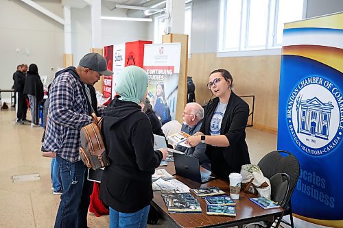 17042024
Jessica Saler, member relations and communications manager with the Brandon Chamber of Commerce, speaks with a visitor to a seminar hosted by Community Futures Westman at the Dome Building for newcomers to Canada looking to start businesses. 
(Tim Smith/The Brandon Sun)