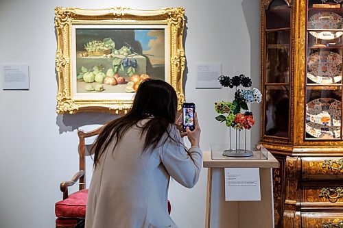 MIKE DEAL / FREE PRESS
Jo&#xeb;lle Preston with Oliva + Olga, takes a photo of her arraignment that goes with the painting Still Life with Fruit by Luis Mel&#xe9;ndez that is on the wall just the pedestal.
109 professional and amateur florists will interpret 94 artworks in the WAG-Qaumajuq collection, filling the galleries with fresh flowers.
240418 - Thursday, April 18, 2024.