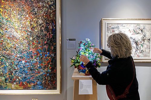 MIKE DEAL / FREE PRESS
Carla Goldstein with WAG-Qaumajuq Associates puts the finishing touches on her arraignment that goes with the huge Jean-Paul Riopelle painting titled Vall&#xe9;e (left) for the Art in Bloom event that is taking place this weekend at the WAG-Qaumajuq.
109 professional and amateur florists will interpret 94 artworks in the WAG-Qaumajuq collection, filling the galleries with fresh flowers.
240418 - Thursday, April 18, 2024.