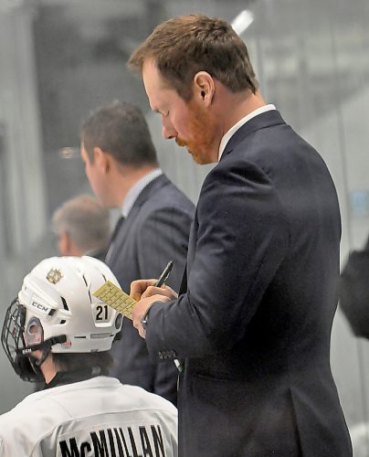 Wheat Kings U18 AAA coach Travis Mealy takes notes from the bench during a playoff game at J&G Homes Arena. (Jules Xavier/The Brandon Sun)