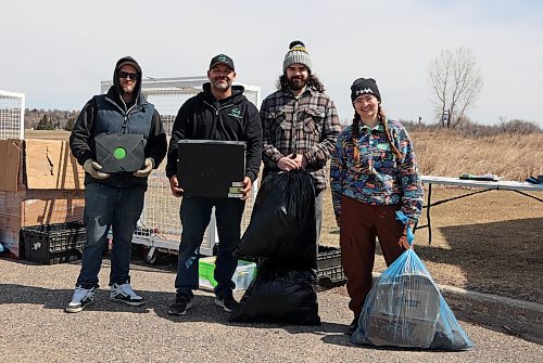 David Mullen (left) and Jim Findley (centre-left) of the Electronic Recycling Association and Dylan Clouthier and NIcole Ziegler of Brandon's Earth Day Committee show off some of the electronic waste and garbage collected during a clean-up event held in several locations around the city on Saturday. (Colin Slark/The Brandon Sun)