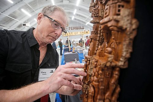 JOHN WOODS / FREE PRESS
Gary Foidart a judge at the Prairie Canada Carvers Association has a look at a bark carving by Brenda Waitt at the annual show at Pembina Curling Club Sunday, April 21, 2024. 

Reporter: s.u.