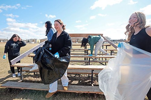 Students from Vincent Massey High School pick up garbage in the school field on Monday for Earth Day. Students in teams for all three Brandon high schools fanned out to clean up garbage in the school neighbourhoods. (Tim Smith/The Brandon Sun)