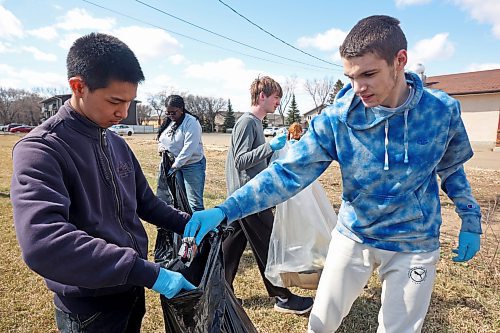 Vincent Massey High School students pick up garbage along McDiarmid Drive near Victoria Avenue on Monday for Earth Day. (Tim Smith/The Brandon Sun)