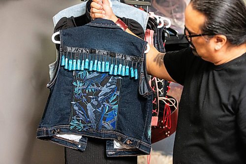 MIKAELA MACKENZIE / FREE PRESS

Cecil Sveinson of Buffalo Dancer Designs holds up one of his vests in his basement studio on Tuesday, April 16, 2024. Sveinson makes ceremonial belts for powwow dancers and other leather goods.

For AV story.