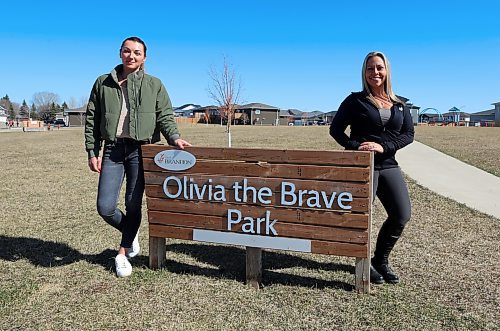 Crystal Baessler (left) and Amber White stand at one of the signs for Olivia the Brave Park in the Brookwood neighbourhood. White led a brief fundraising campaign to boost the budget for a new play structure at the park, which is named in honour of Baessler's daughter. More than $155,000 was raised. (Colin Slark/The Brandon Sun)