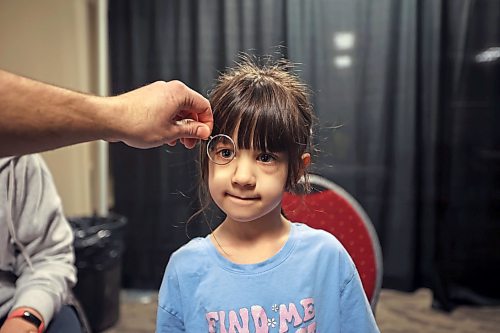 Four-year-old Julie Spence has her vision tested during the Preschool Wellness Fair at Keystone Centre on Tuesday. (Tim Smith/The Brandon Sun)