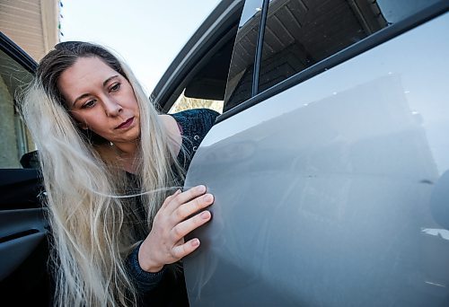 JOHN WOODS / FREE PRESS
Cassie Fotheringham checks the scratch on her vehicle after she alleges a person sideswiped her suv in Winnipeg Tuesday, April 23, 2024. Fotheringham alleges MPI found her husband 50% responsible for the collision.

Reporter: malak