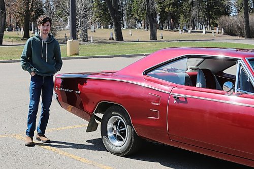 Nate Buhler stands next to the 1968 Dodge Coronet 440 that his grandfather restored. (Charlotte McConkey/The Brandon Sun)