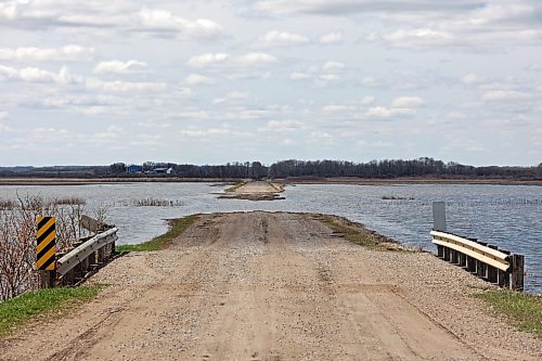 Flood water from the swollen Assiniboine River washes out a grid road off of Highway 250 north of Alexander on Tuesday. (Tim Smith/The Brandon Sun)
