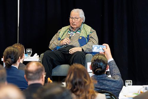 MIKE DEAL / FREE PRESS
Premier Wab Kinew takes a photo with his phone while Justice Murray Sinclair speaks during the opening remarks of Public Safety Summit taking place at the RBC Convention Centre.
240430 - Tuesday, April 30, 2024.