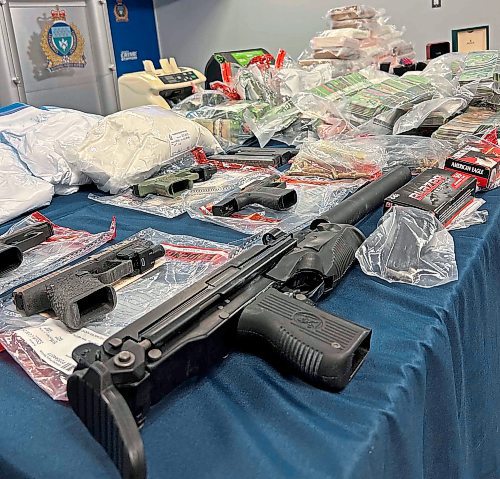 Police seized $1.7 million in cash, 30 kg of cocaine, four handguns, a submachine-gun with a silencer, and ammunition. (Tyler Searle / Free Press)
