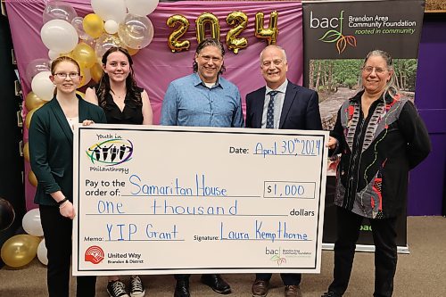 Youth in Philanthropy at Vincent Massey president Abby Wruth (from left), vice-president Allison McQuigge, Brandon Mayor Jeff Fawcett, Brandon School Division superintendent Mathew Gustafson and Samaritan House Ministries food bank co-ordinator Marcia Hamm-Wiebe at the grant presentation on Tuesday. (Abiola Odutola/The Brandon Sun)