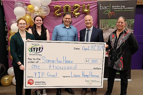 Youth in Philanthropy at Vincent Massey president Abby Wruth (from left), vice-president Allison McQuigge, Brandon Mayor Jeff Fawcett, Brandon School Division superintendent Mathew Gustafson and Samaritan House Ministries food bank co-ordinator Marcia Hamm-Wiebe at the grant presentation on Tuesday. (Abiola Odutola/The Brandon Sun)