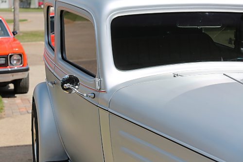 Side and mirror view of Al Gray's 1934 Chevy truck. Gray buffed off the black paint to expose the steel underneath. (Charlotte McConkey/The Brandon Sun)