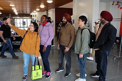Left: ACC new international students Zanhong Xin from China, Titilope Ajao from Nigeria,  Harpreet Singh from India, Haonan Li from China and Manpreet Singh take selfie during the orientation program on Wednesday.  Photo: Abiola Odutola/The Brandon Sun