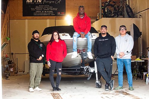MIKAELA MACKENZIE / FREE PRESS

Anthony dela Cruz (left), Alexis Tachnak, Quinnell Joseph, Daniel Hidalgo, and Michael Richard with Community204&#x573; new boat, which will be used to patrol waterways to offer safety and support to people living in encampments near riverbanks, at the shop where it will be getting logos applied on Thursday, May 2, 2024. 


For Tyler story.