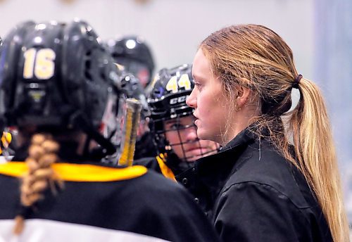 Brandon Wheat Kings U15 AAA coach Karissa Kirkup has watched her players win the Manitoba Female Hockey League playoff title in back-to-back seasons. Here, she offers game strategy during a timeout with her players during a 2023-24 regular season game played at J&G Homes Arena. (Jules Xavier/The Brandon Sun)