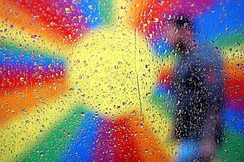 The colourful rainbow mural in an alleyway along Rosser Avenue in downtown Brandon is refracted by raindrops on a car window as a pedestrian passes by during showers on Thursday afternoon. Environment Canada is forecasting more showers for today, ending late in the evening. (Tim Smith/The Brandon Sun)