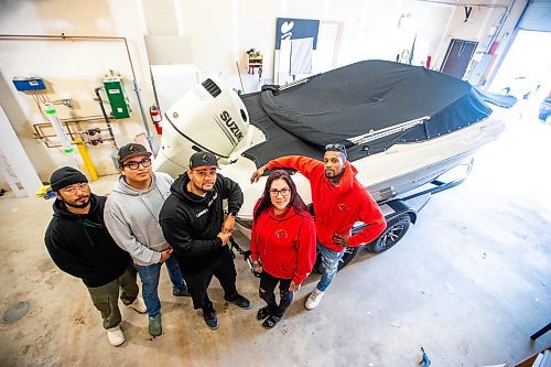 MIKAELA MACKENZIE / FREE PRESS

Anthony dela Cruz (left), Michael Richard, Daniel Hidalgo, Alexis Tachnak, and Quinnell Joseph with Community204&#x573; new boat, which will be used to patrol waterways to offer safety and support to people living in encampments near riverbanks, at the shop where it will be getting logos applied on Thursday, May 2, 2024. 


For Tyler story.