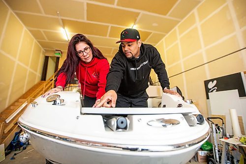 MIKAELA MACKENZIE / FREE PRESS

Alexis Tachnak (left) and Daniel Hidalgo with Community204 check out their new boat, which will be used to patrol waterways to offer safety and support to people living in encampments near riverbanks, at the shop where it will be getting logos applied on Thursday, May 2, 2024. 


For Tyler story.