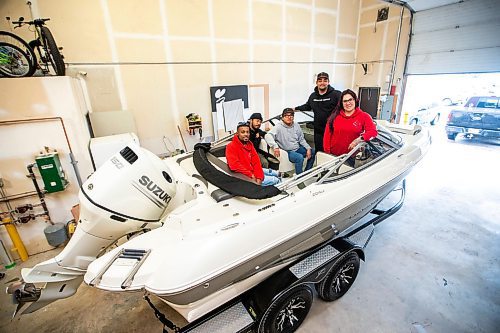 MIKAELA MACKENZIE / FREE PRESS

Quinnell Joseph (left), Anthony dela Cruz, Michael Richard, Daniel Hidalgo, and Alexis Tachnak with Community204&#x573; new boat, which will be used to patrol waterways to offer safety and support to people living in encampments near riverbanks, at the shop where it will be getting logos applied on Thursday, May 2, 2024. 


For Tyler story.