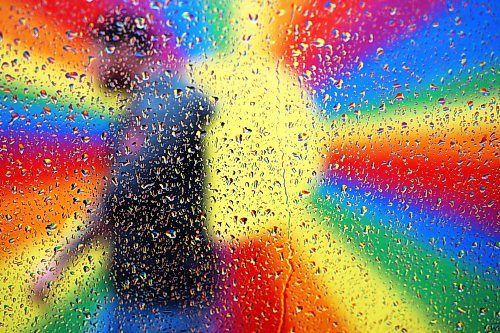 02052024
The colourful rainbow mural in an alleyway along Rosser Avenue in downtown Brandon is refracted by raindrops on a car window as a pedestrian passes by during showers on Thursday afternoon.
(Tim Smith/The Brandon Sun)