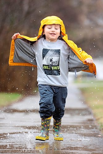 02052024
Four-year-old Kieran MacMillan plays in a puddle outside his home in Minnedosa on a rainy Thursday afternoon. (Tim Smith/The Brandon Sun)