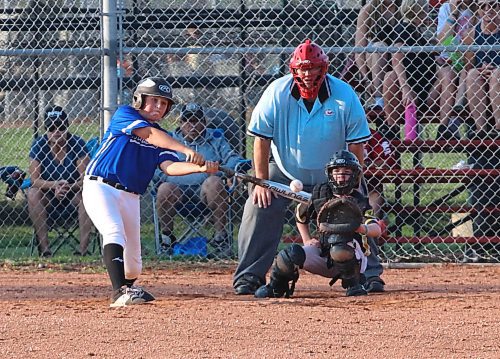 Dodgers hitter Cole Adams gets the bat on the ball during the Brandon Minor Baseball Association’s U15 final at Simplot Millennium Park as Padres catcher Brady Reid and umpire Jack Reynolds look on. Reynolds, who serves as umpire-in-chief in Brandon, said the number of baseball officials is down slightly this summer. (Perry Bergson/The Brandon Sun)