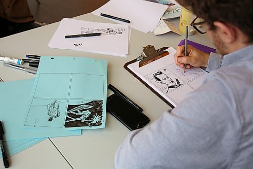 Jeremy Carter doing inkwork for a comic at the AGSM's Free Comic Book Day. (Charlotte McConkey/The Brandon Sun)