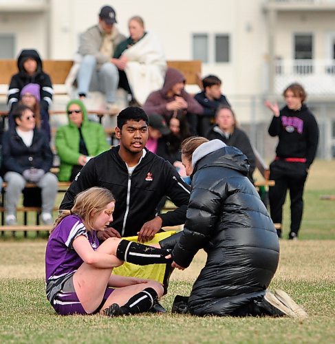 Vincent Massey Vikings girls' rugby assistant coach Jerome Cruz and head coach Nancy Pitcairn check on an injured player during a Westman High School Rugby league game versus the Souris Sabres. (Jules Xavier/The Brandon Sun)