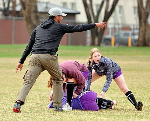 During a pre-game warmup, Vincent Massey Vikings girls' rugby assistant coach Jerome Cruz directs his players during a ruck positioning. (Jules Xavier/The Brandon Sun)