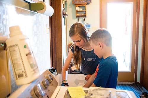 MIKAELA MACKENZIE / FREE PRESS

Alexa (left, 11) and Micah (eight) Bouw measure out powdered milk formula for a bottle-fed calf on Edie Creek Angus ranch near Anola on Wednesday, May 8, 2024. 


