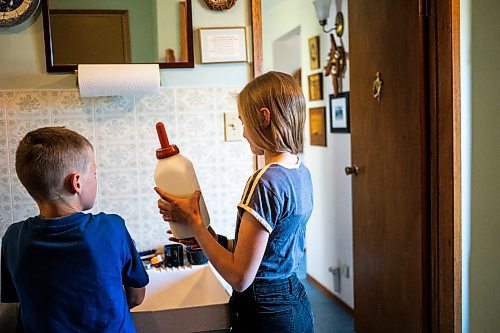 MIKAELA MACKENZIE / FREE PRESS

Micah (left, eight) and Alexa (11) Bouw measure out powdered milk formula for a bottle-fed calf on Edie Creek Angus ranch near Anola on Wednesday, May 8, 2024. 


