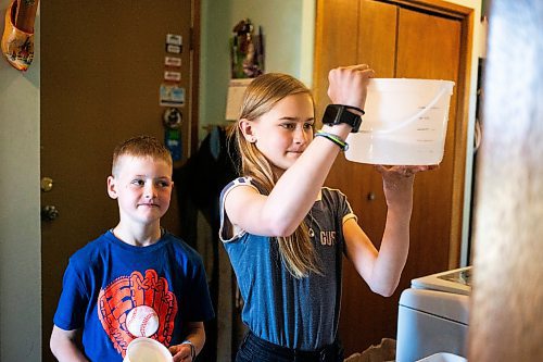 MIKAELA MACKENZIE / FREE PRESS

Alexa (right, 11) and Micah (eight) Bouw measure out powdered milk formula for a bottle-fed calf on Edie Creek Angus ranch near Anola on Wednesday, May 8, 2024. 


