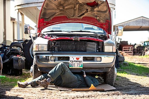 MIKAELA MACKENZIE / FREE PRESS

Jonathan Bouw works underneath a truck on Edie Creek Angus ranch near Anola on Wednesday, May 8, 2024. 


