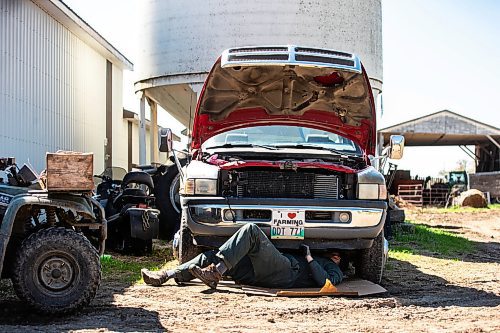 MIKAELA MACKENZIE / FREE PRESS
Jonathan Bouw works underneath a truck on Edie Creek Angus ranch near Anola on Wednesday, May 8, 2024.