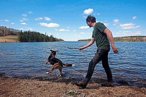 09052024
Johannes Wingefeld throws a stick for his dog Willy while visiting Riding Mountain National Park from Germany with his partner Janine Wingefeld on Thursday. The Wingefeld&#x2019;s are spending six month&#x2019;s travelling Canada and began their trip five weeks ago in Halifax.
(Tim Smith/The Brandon Sun)