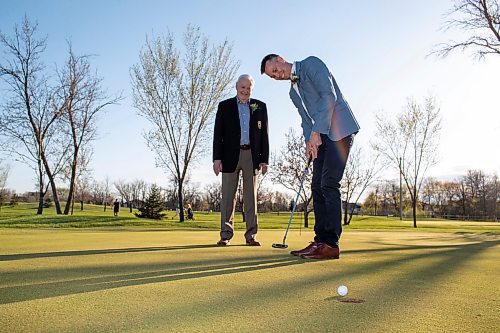 BROOK JONES / FREE PRESS
Adam Speirs, 45, watches his putt as his dad Gavin Speirs, 79, calls the line of play while they duo fun together and test their golf skills on the putting green prior to being inducted into the Manitoba Golf Hall of Fame at the Breeszy Bend Country Club in Headingley, Man., Thursday, May 9, 2024. Adam was honoured for the class of 2023 and Gavin was honoured for the class of 2022.
