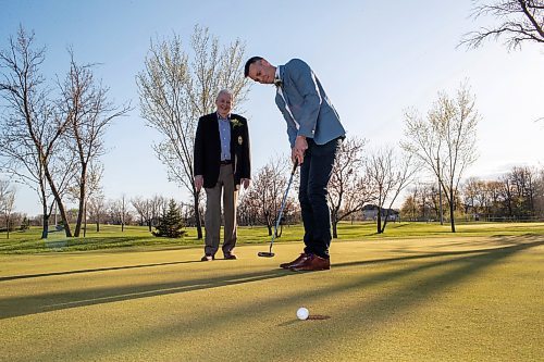 BROOK JONES / FREE PRESS
Adam Speirs, 45, watches his putt as his dad Gavin Speirs, 79, calls the line of play while the duo have fun together and test their golf skills on the putting green prior to being inducted into the Manitoba Golf Hall of Fame at the Breeszy Bend Country Club in Headingley, Man., Thursday, May 9, 2024. Adam was honoured for the class of 2023 and Gavin was honoured for the class of 2022.