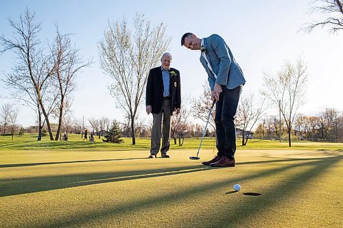 BROOK JONES / FREE PRESS
Adam Speirs, 45, watches his putt as his dad Gavin Speirs, 79, calls the line of play while duo have fun together and test their golf skills on the putting green prior to being inducted into the Manitoba Golf Hall of Fame at the Breeszy Bend Country Club in Headingley, Man., Thursday, May 9, 2024. Adam was honoured for the class of 2023 and Gavin was honoured for the class of 2022.