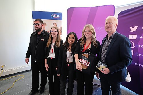 Left: Fusion Credit Union representative, 2024 Manitoba High School Case Competition Personal Finance category (winners) Crocus Plains Regional Secondary School students  Beverley Mahoney, Ashnoor Kalra, Preston Clipping and Assiniboine College’s Peters School of Business academic chair Geoff Milne at the college on Friday. Photos: Abiola Odutola/The Brandon Sun.