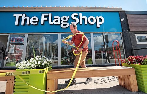 Ruth Bonneville / Free Press

BIZ - Flag Shop

Photo of  Samantha's husband, Mathew Hobson,  setting out benches outside the shop.  

Samantha and her husband Mathew Hobson,  alongside her parents Guy &amp; Magda Gauthier. 

Story: The Flag Shop, is holding a grand-re-opening event on Sat May 11 at its new location on south Osborne. The store opened on Pembina Hwy in 1996 as  a family-run venture: 

There are various pics filed for the new store including: exterior shot (Mathew putting out benches), shots of the various merchandise - country flags, group photo, store mascot - 6-month old Griffin sporting a Canada Flag bandana and Magda (mom) hard @ work - she's the entire sewing department.

Dave Sanderson 

May 10th, 2024
