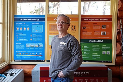 09052024
George Hartlen, CAO of Friends of Riding Mountain National Park, at the non-profit organizations’ centre in Wasagaming on Friday. The centre has a variety of information on zebra mussels to help educate visitors about the risks of the invasive species. (Tim Smith/The Brandon Sun)