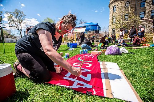 MIKAELA MACKENZIE / FREE PRESS

Community member Sharon Johnson paints a banner as a pro-Palestinian encampment sets up at the University of Winnipeg on Friday, May 10, 2024. 

For Jen story.

