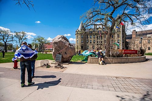 MIKAELA MACKENZIE / FREE PRESS

A man wears an Israeli flag on the sidewalk as a pro-Palestinian encampment sets up on the lawn at the University of Winnipeg on Friday, May 10, 2024. 

For Jen story.

