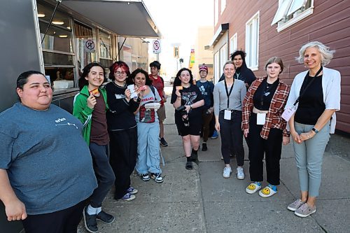 Left: Huddle Brandon's peer supporter Anita Labonte and some youth pose for a picture by the food truck on Friday. Photos: Abiola Odutola/The Brandon Sun