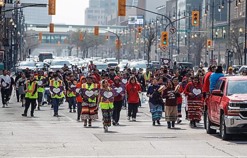 JOHN WOODS / FREE PRESS
family and supporters of MMIWGs walk past the site of the former St Regis Hotel to the Forks for ceremonies in support of families in Winnipeg Sunday, May 12, 2024. The annual event was created  twenty years ago after Sunshine Wood went missing from the St Regis hotel.

Reporter: Tyler